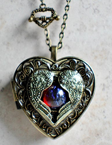 Angel wing music box locket, heart locket with music box inside with dragons breath cabochon.