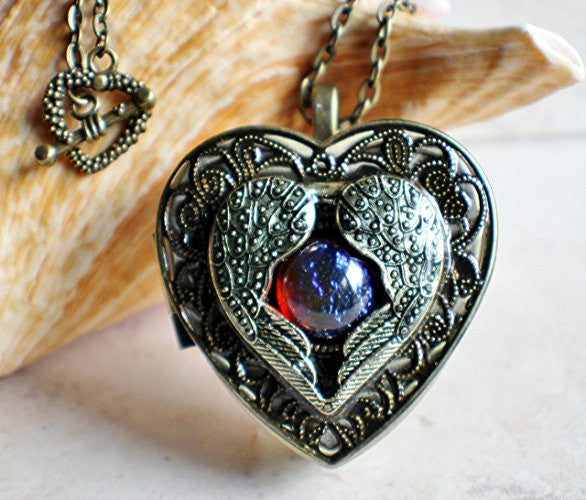 Angel wing music box locket, heart locket with music box inside with dragons breath cabochon.