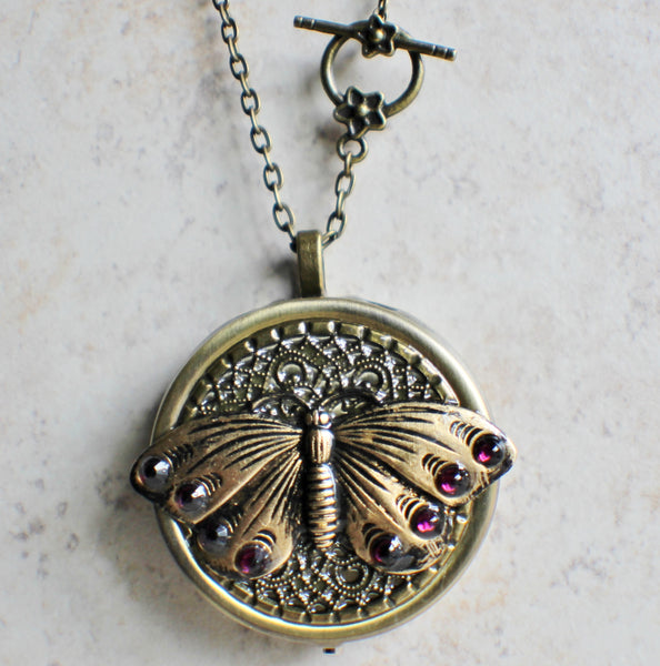 Music box locket,  round locket with music box inside, in bronze with filigree and butterfly adorning front cover. - Char's Favorite Things - 4