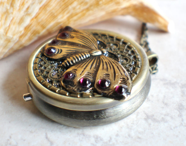 Music box locket,  round locket with music box inside, in bronze with filigree and butterfly adorning front cover. - Char's Favorite Things - 2