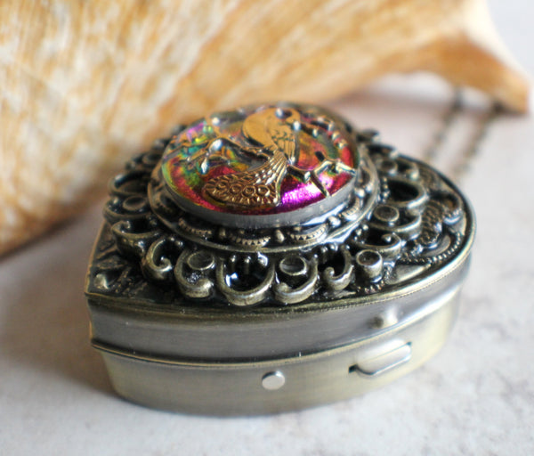 Peacock Music box locket, heart shaped with bronze accents.