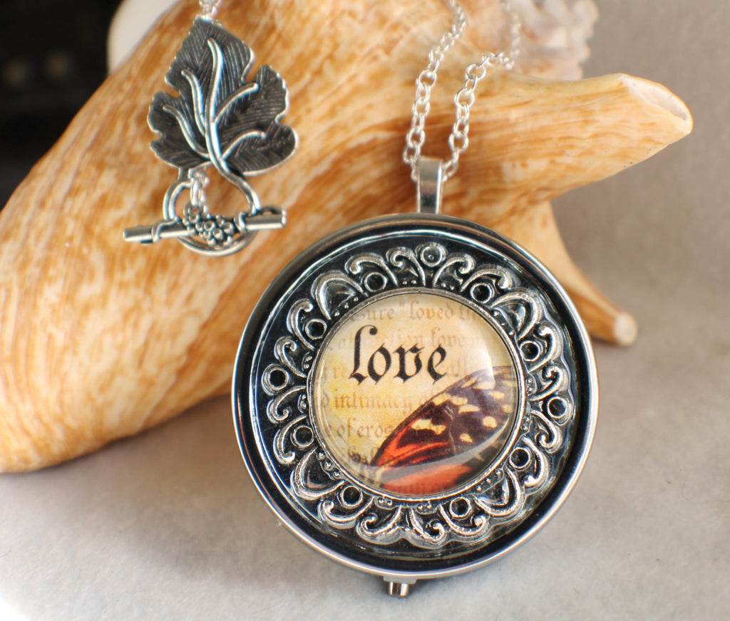Music box locket, round locket with music box inside, in silver tone with Love and Butterfly Cabochon - Char's Favorite Things - 1