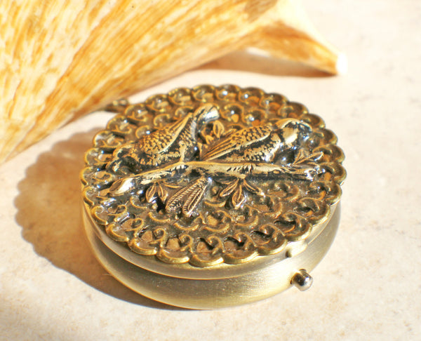 Music box locket, round bronze locket with music box inside, with a bronze filigree and a bronze birds on front cover. - Char's Favorite Things - 2