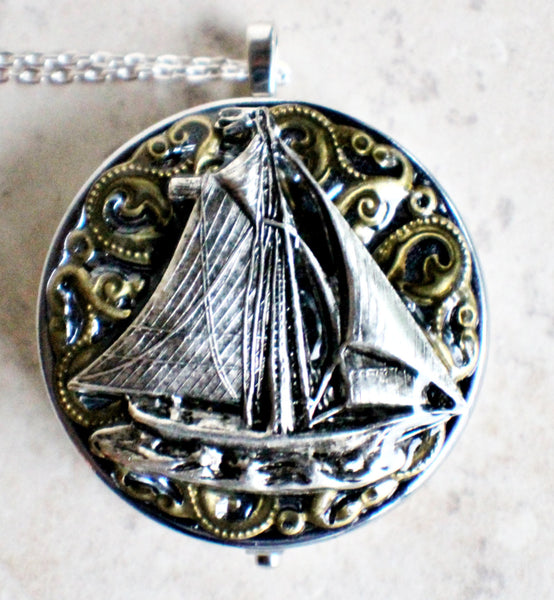 Music box locket, round silver tone locket with music box inside, with a nautical theme featuring a sailboat on front cover. - Char's Favorite Things - 3