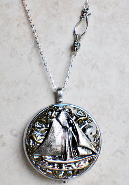 Music box locket, round silver tone locket with music box inside, with a nautical theme featuring a sailboat on front cover. - Char's Favorite Things - 4