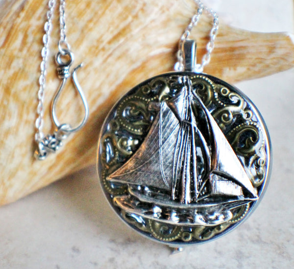 Music box locket, round silver tone locket with music box inside, with a nautical theme featuring a sailboat on front cover. - Char's Favorite Things - 1