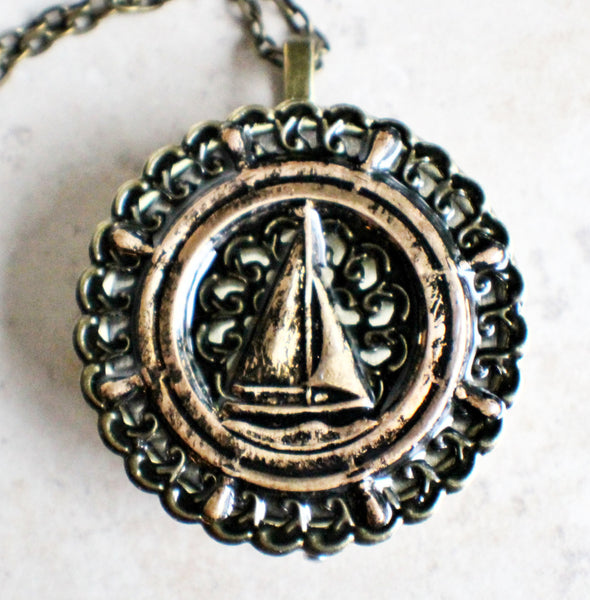 Music box locket, round bronze locket with music box inside, with a nautical theme featuring a sailboat on front cover. - Char's Favorite Things - 3